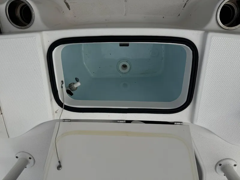 Slide: The Image of 2018 Robalo R200 Center Console livewell with open lid, showcasing interior. - 8