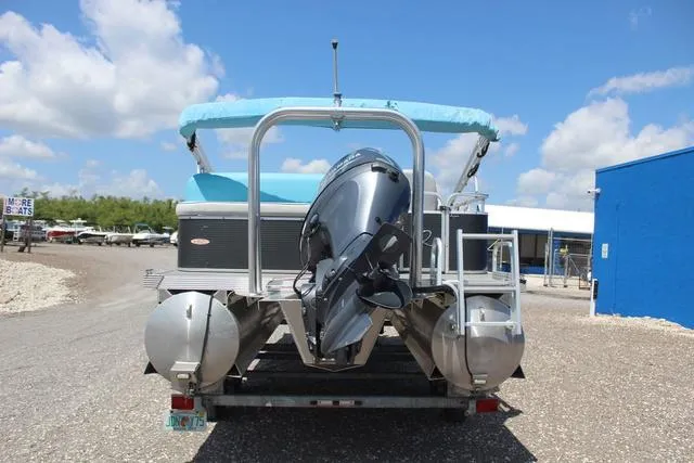 Slide: The Image of 2018 Apex Marine 820 VX Cruise pontoon boat with outboard motor, parked outdoors. - 5