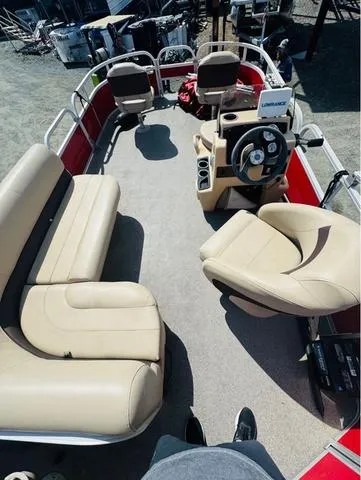Slide: The Image of 2017 Tracker Bass Buggy 18 DLX boat interior with beige seating and steering console. - 4