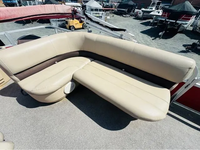Slide: The Image of 2017 Tracker Bass Buggy 18 DLX boat with beige seating, docked outdoors. - 7