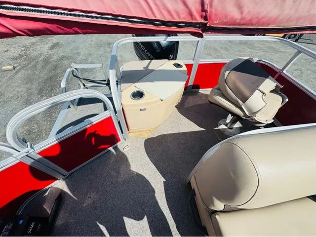 Slide: The Image of 2017 Tracker Bass Buggy 18 DLX boat interior with seating and red accents. - 9