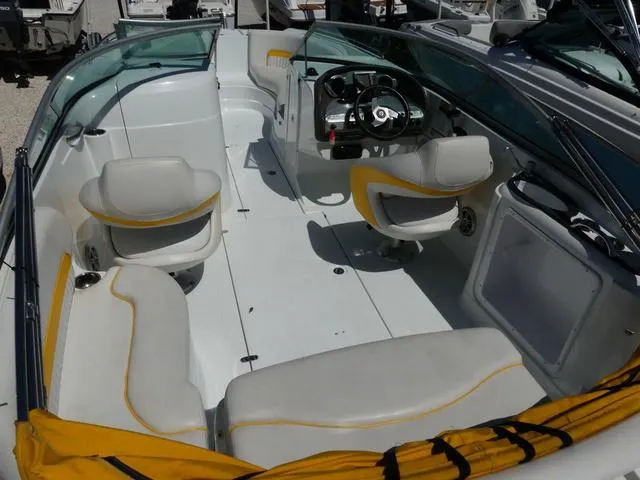 Slide: The Image of 2011 SouthWind 2400 Bowrider boat interior with white and yellow seating. - 5