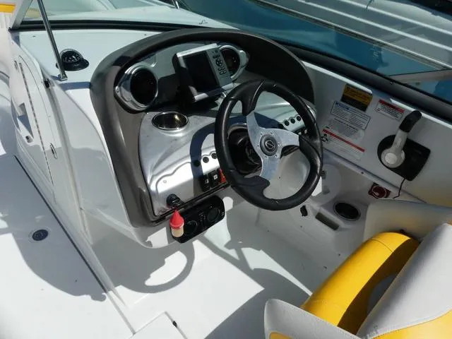 Slide: The Image of 2011 SouthWind 2400 Bowrider boat dashboard with steering wheel and controls. - 7