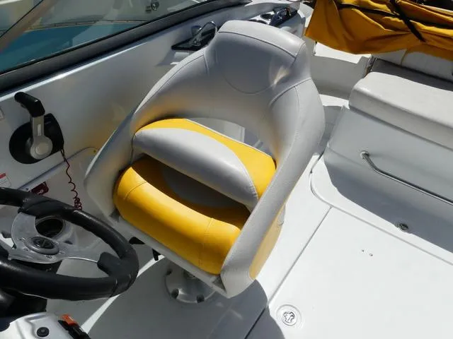 Slide: The Image of Captain's seat on 2011 SouthWind 2400 Bowrider boat, featuring yellow and white upholstery. - 8