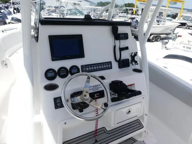 Slide: The Image of 2019 Sea Fox 266 Commander boat dashboard with steering wheel and navigation controls. - 10