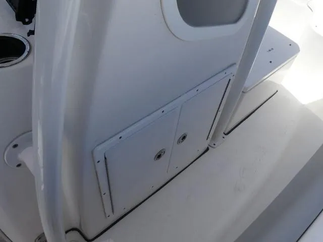Slide: The Image of 2019 Sea Fox 266 Commander boat interior, featuring storage compartment and cup holder. - 17