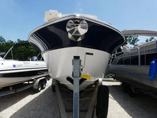 Slide: The Image of 2019 Sea Fox 266 Commander boat on trailer, front view, parked outdoors. - 2