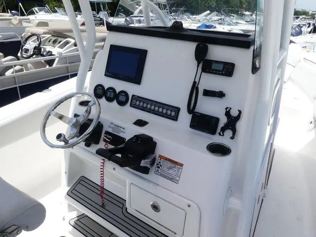Slide: The Image of Control panel of 2019 Sea Fox 266 Commander boat with steering wheel and navigation equipment. - 8