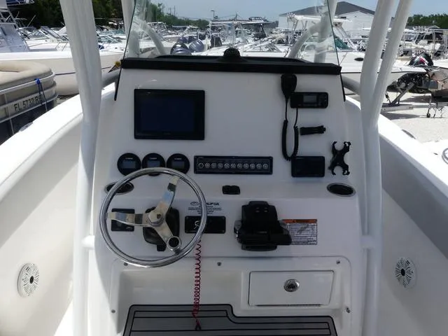 Slide: The Image of 2019 Sea Fox 266 Commander boat dashboard with steering wheel and navigation controls. - 9