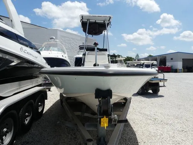 Slide: The Image of 2017 Mako 21 LTS boat on trailer in sunny marina setting. - 2