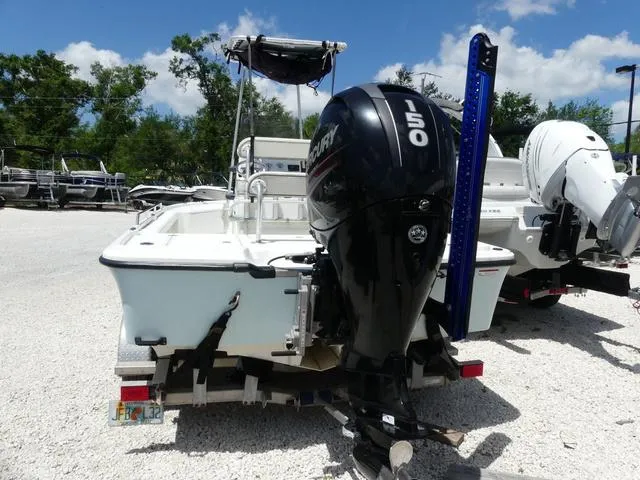Slide: The Image of 2017 Mako 21 LTS boat with Mercury 150 engine, parked on gravel lot. - 4