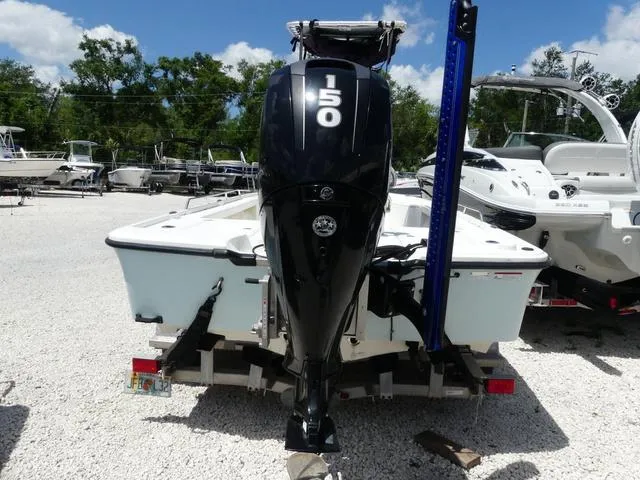 Slide: The Image of 2017 Mako 21 LTS boat with 150 HP engine, parked on gravel lot. - 5