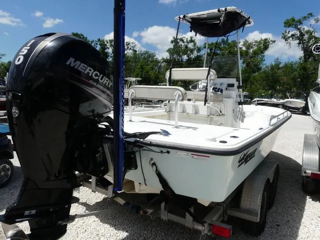 Slide: The Image of 2017 Mako 21 LTS boat with Mercury engine on trailer, parked outdoors. - 6