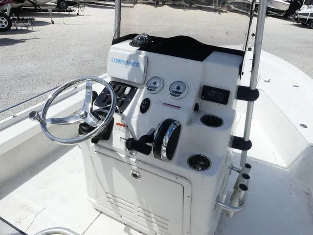 Slide: The Image of 2017 Mako 21 LTS boat console with steering wheel and navigation controls. - 7