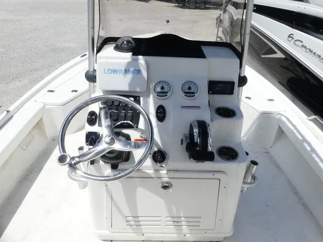 Slide: The Image of Center console of a 2017 Mako 21 LTS boat with steering wheel and controls. - 8