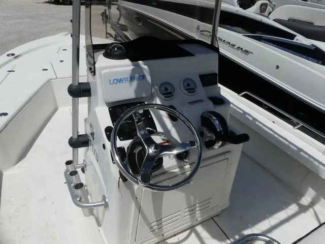 Slide: The Image of 2017 Mako 21 LTS boat console with steering wheel and Lowrance electronics. - 9