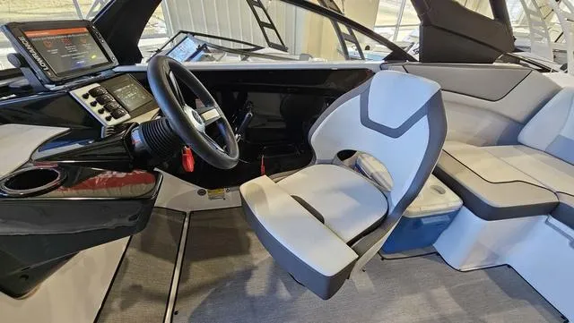 Slide: The Image of 2023 Yamaha Boats AR 220 interior with steering wheel and seating area. - 12