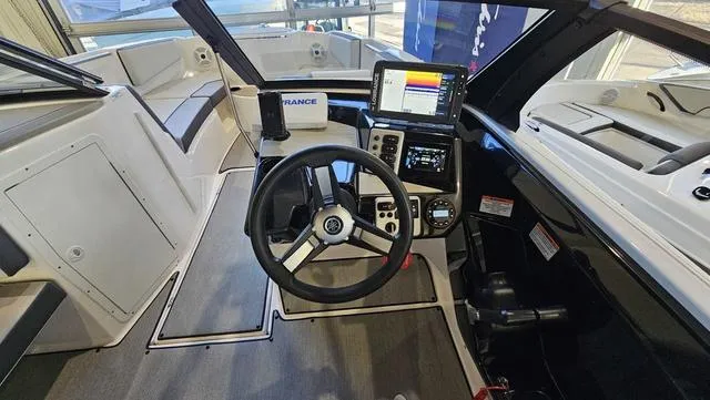 Slide: The Image of 2023 Yamaha Boats AR 220 cockpit with steering wheel and modern navigation system. - 14