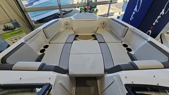 Slide: The Image of 2023 Yamaha Boats AR 220 interior with spacious seating and modern design. - 19