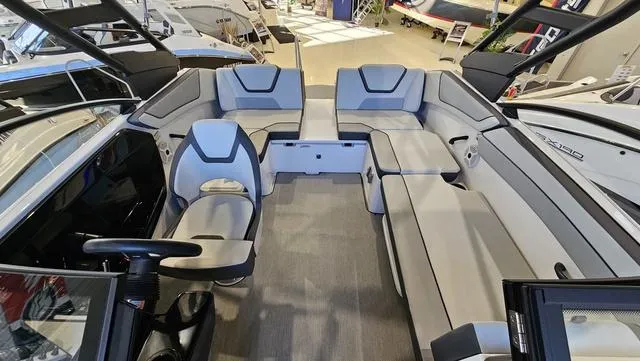 Slide: The Image of 2023 Yamaha Boats AR 220 interior with spacious seating and modern design. - 8