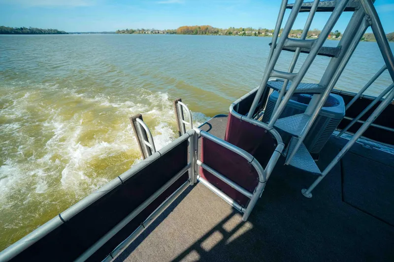Slide: The Image of 1999 Sumerset houseboat deck with water view and metal ladder. - 10