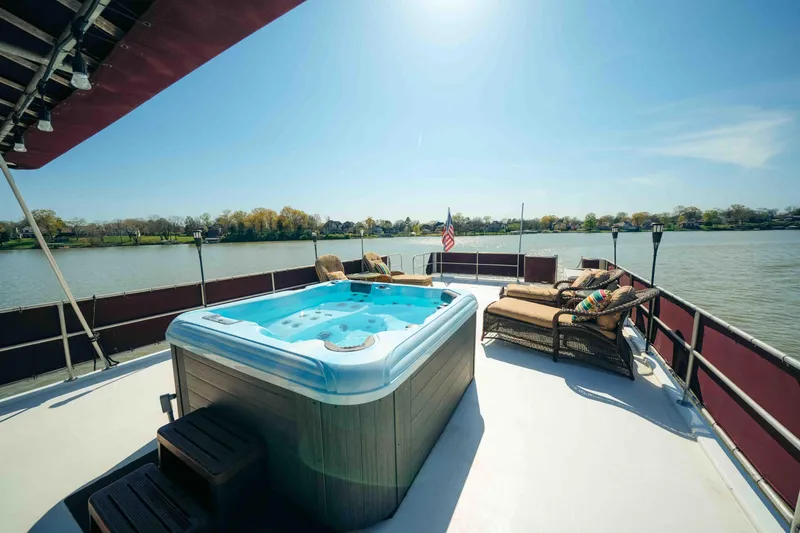 Slide: The Image of 1999 Sumerset houseboat deck with hot tub, lounge chairs, and scenic lake view. - 19