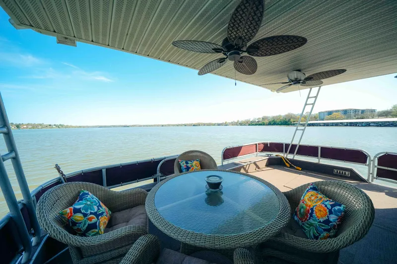 Slide: The Image of 1999 Sumerset houseboat cruising on a calm river under a clear blue sky. - 2