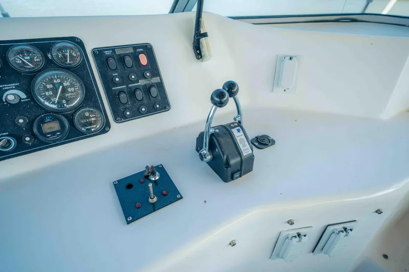 Slide: The Image of 1999 Sumerset houseboat control panel with gauges and throttle levers. - 27