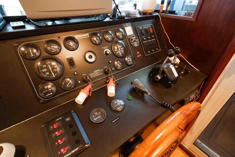 Slide: The Image of Control panel of a 1999 Sumerset houseboat with gauges and steering wheel. - 31