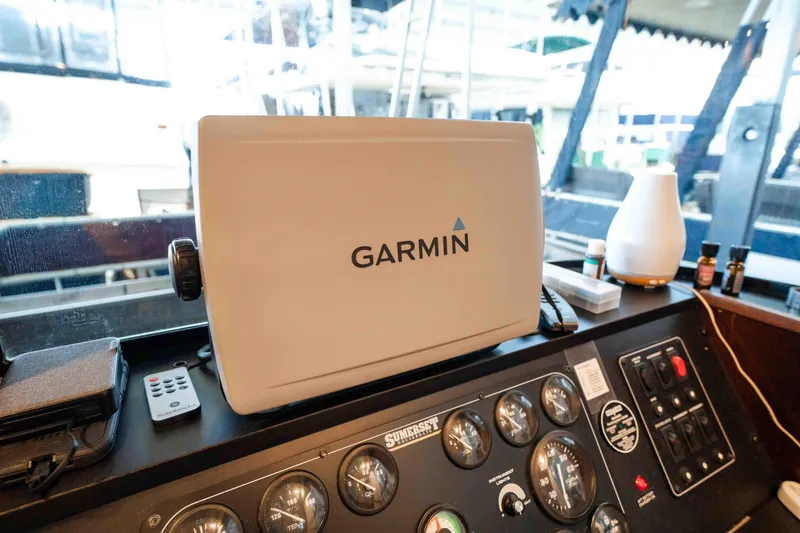 Slide: The Image of Control panel of a 1999 Sumerset houseboat featuring Garmin navigation equipment. - 33