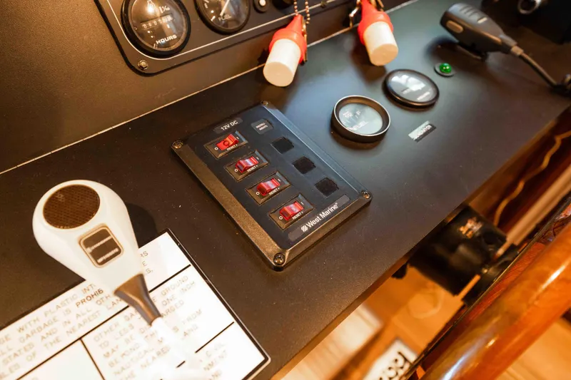 Slide: The Image of Control panel of a 1999 Sumerset houseboat with switches and gauges. - 35