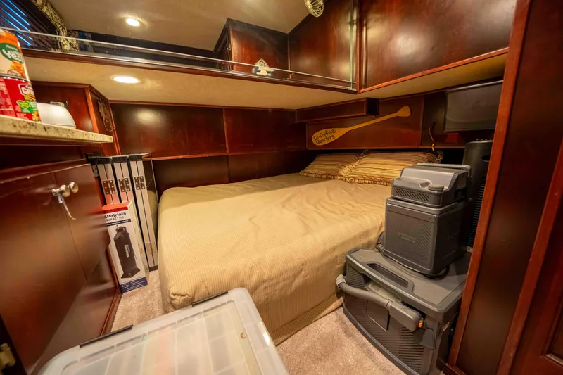 Slide: The Image of Cozy bedroom in a 1999 Sumerset houseboat with wooden cabinetry and storage. - 49