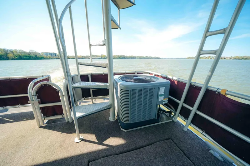 Slide: The Image of 1999 Sumerset houseboat deck with spiral staircase and air conditioning unit. - 8