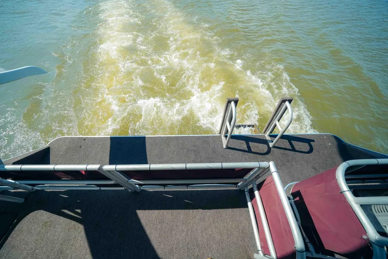 Slide: The Image of 1999 Sumerset houseboat deck with water wake and ladder. - 9