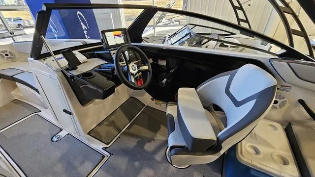 Slide: The Image of 2023 Yamaha Boats AR 220 interior with modern dashboard and comfortable seating. - 13
