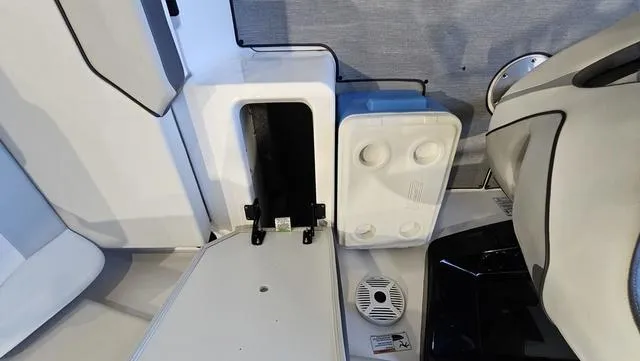 Slide: The Image of 2023 Yamaha AR 220 boat interior with storage compartment and speaker. - 23