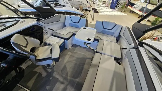 Slide: The Image of 2023 Yamaha Boats AR 220 interior with spacious seating and modern design. - 11