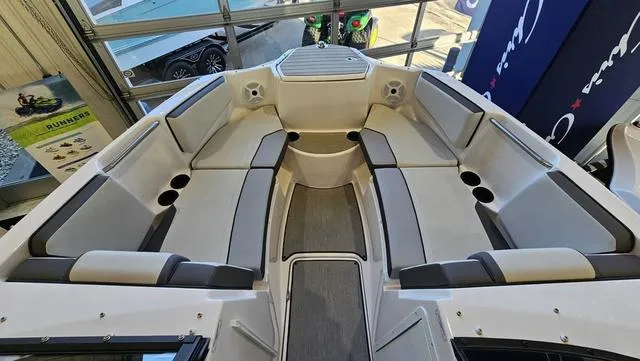 Slide: The Image of 2023 Yamaha Boats AR 220 interior with spacious seating and modern design. - 17