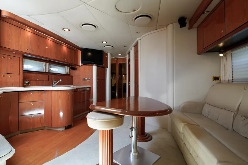 Slide: The Image of Interior of 2000 Sea Ray 510 Sundancer yacht with kitchen, dining table, and sofa. - 10