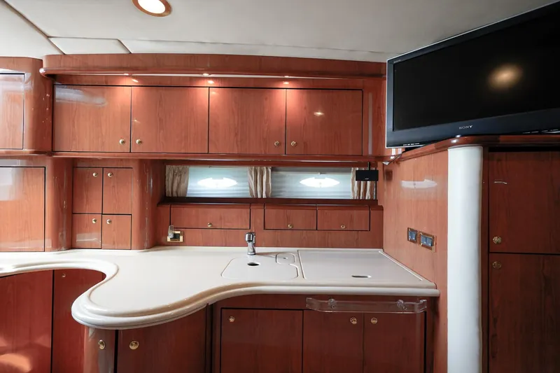 Slide: The Image of Luxurious interior of 2000 Sea Ray 510 Sundancer yacht with wood cabinetry and modern amenities. - 11
