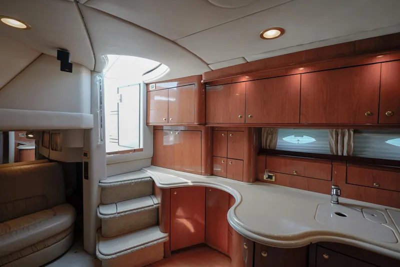 Slide: The Image of Luxurious interior of 2000 Sea Ray 510 Sundancer yacht with elegant wood cabinetry and modern design. - 12