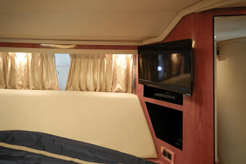 Slide: The Image of Luxurious cabin interior of 2000 Sea Ray 510 Sundancer with TV and elegant curtains. - 17