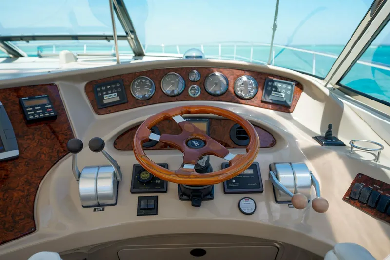 Slide: The Image of Cockpit of 2000 Sea Ray 510 Sundancer with wooden steering wheel and control panel. - 24