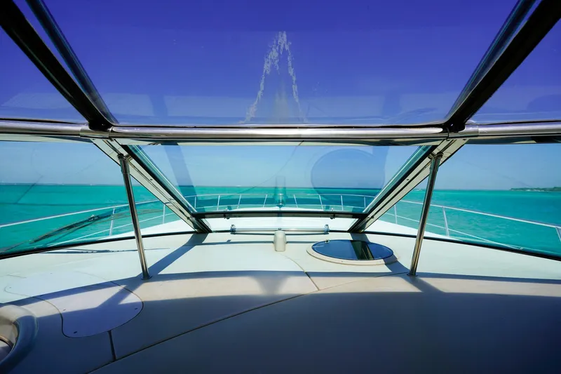 Slide: The Image of Sea Ray 510 Sundancer yacht, 2000 model, cruising on clear turquoise waters under a blue sky. - 26