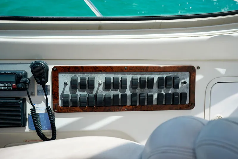 Slide: The Image of Control panel of a 2000 Sea Ray 510 Sundancer yacht with switches and a radio. - 28