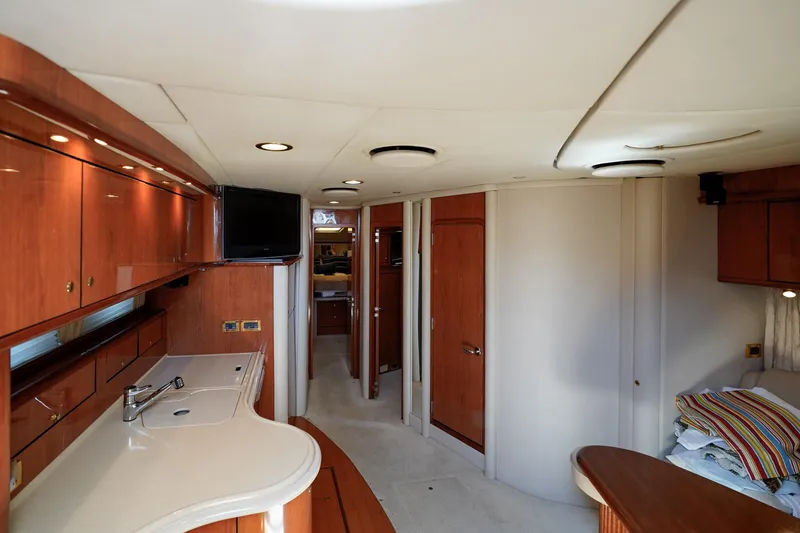 Slide: The Image of Interior of 2000 Sea Ray 510 Sundancer yacht with modern wood cabinetry and sleek design. - 4