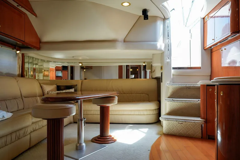 Slide: The Image of Luxurious interior of a 2000 Sea Ray 510 Sundancer yacht with elegant seating and wooden accents. - 6
