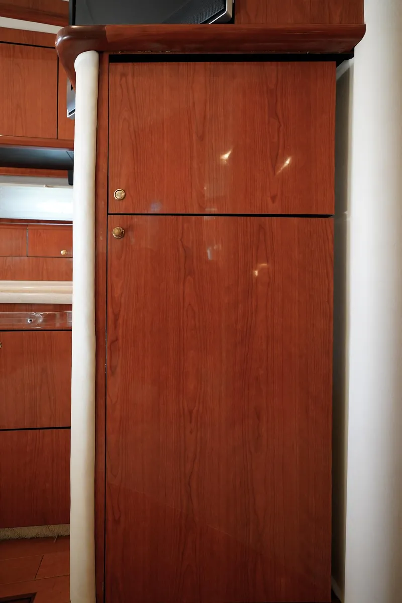 Slide: The Image of Wooden cabinet interior of 2000 Sea Ray 510 Sundancer yacht. - 8