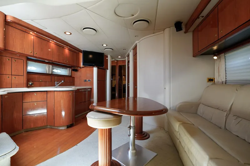Slide: The Image of Luxurious interior of 2000 Sea Ray 510 Sundancer yacht with wood cabinetry and plush seating. - 9