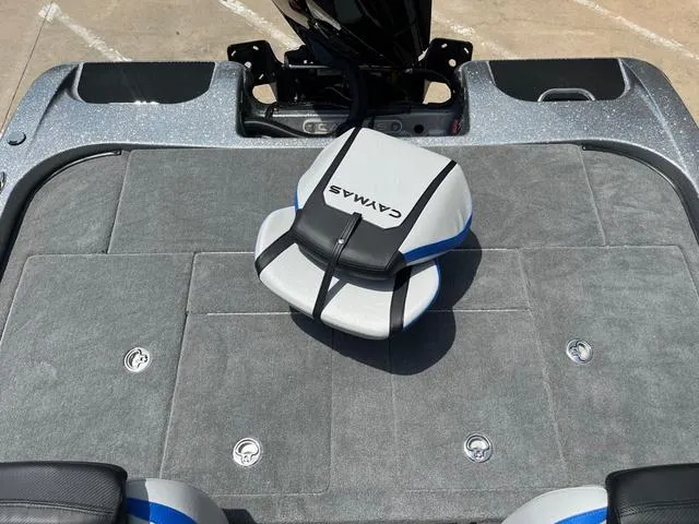 Slide: The Image of 2025 Caymas CX21 Pro boat deck with cushioned seating and storage compartments. - 10